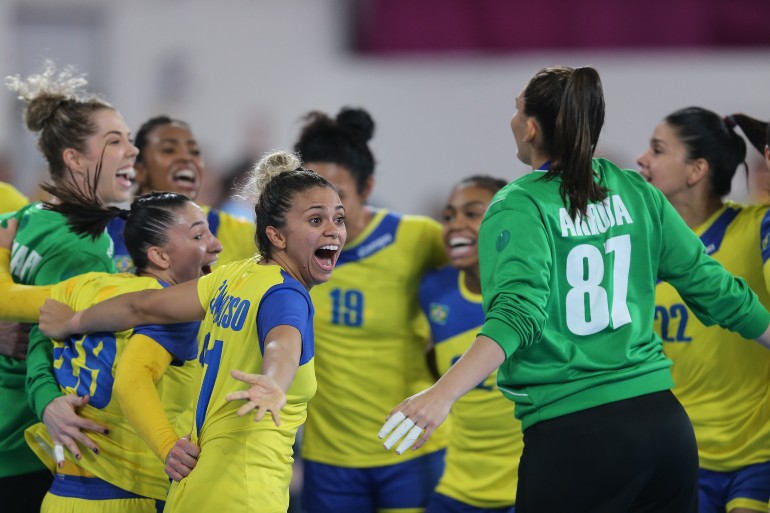 Jogadoras de handebol comemoram